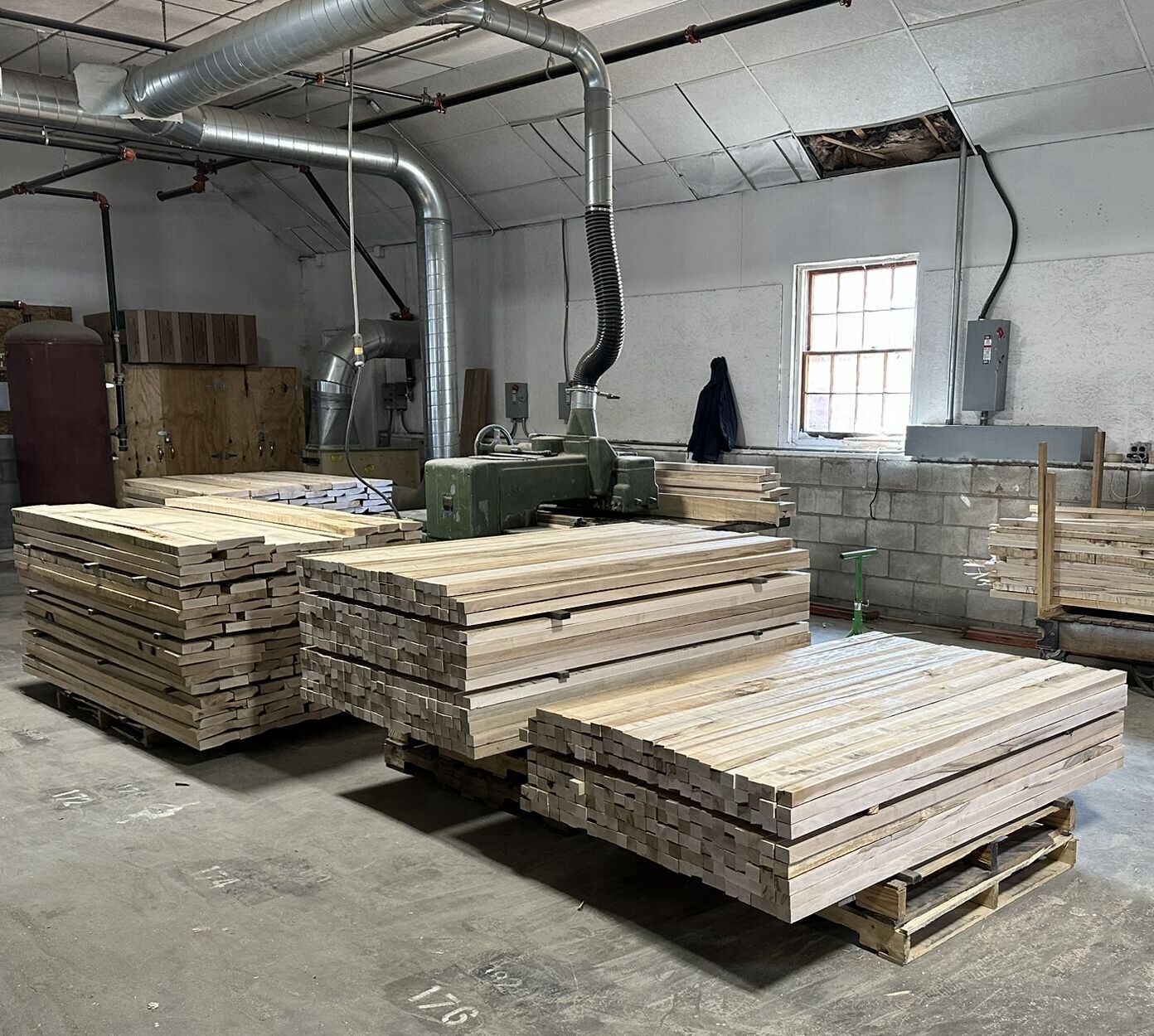 Solid wood closet uprights being machined in production