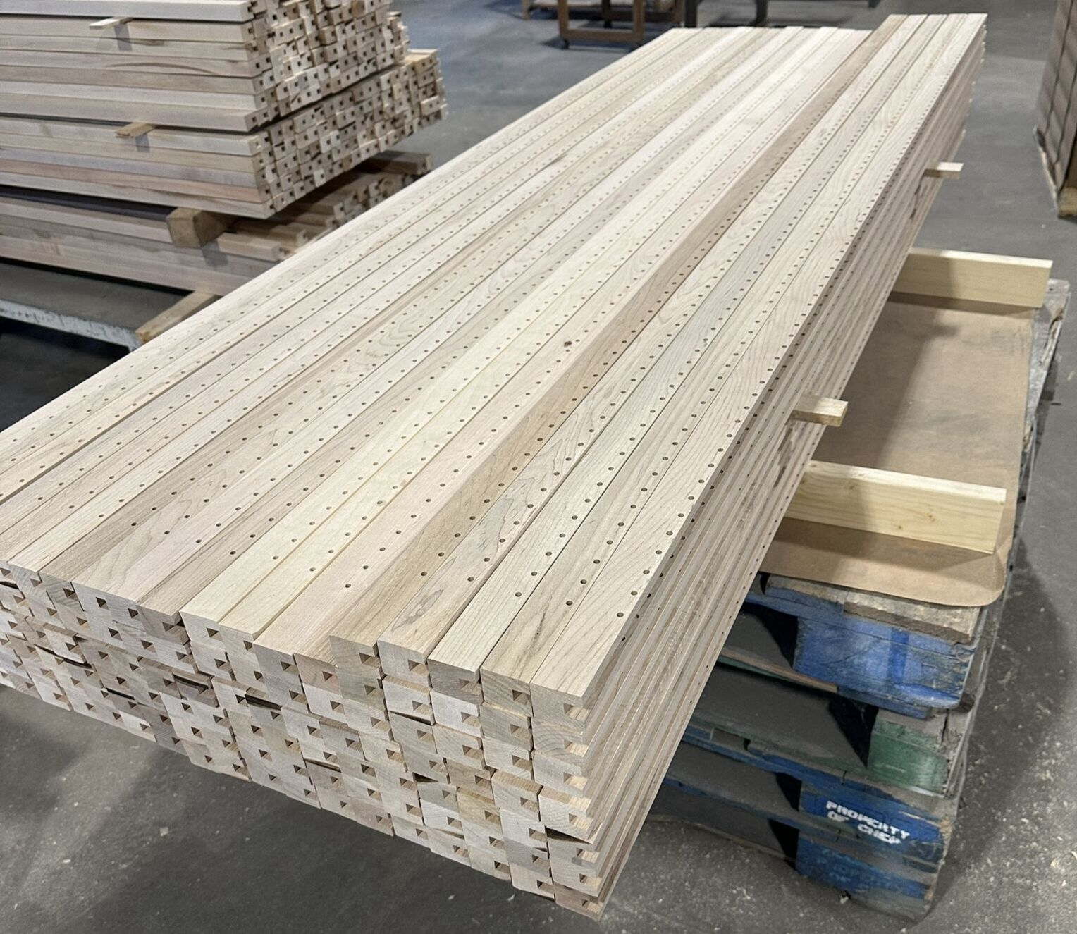 Drilled hardwood maple uprights staged and ready to be assembled